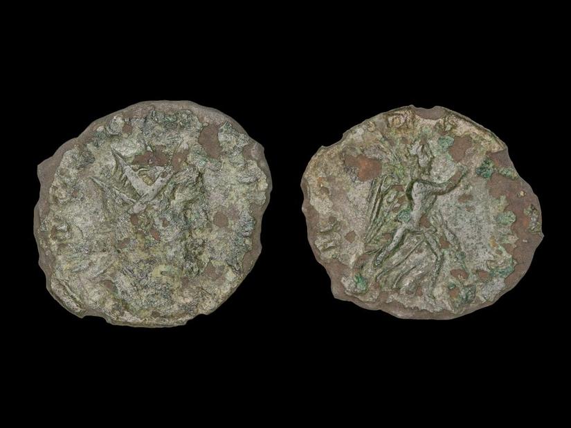 Two sides of the Roman coin laid out on a dark background